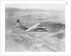Airplane Flying Over Landscape by Anonymous