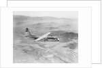 Airplane Flying Over Landscape by Anonymous