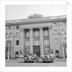 Cars Parked in Front of a Hotel by Anonymous