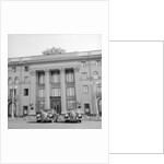 Cars Parked in Front of a Hotel by Anonymous