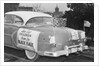 Automobile Decorated with Signs and American Flags by Anonymous