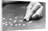 Hand Holding Pills Containing Thalidomide by Anonymous