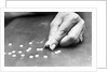 Hand Holding Pills Containing Thalidomide by Anonymous