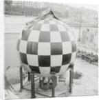 Checkered Steel Sphere Resting on Platform by Anonymous