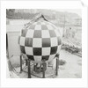 Checkered Steel Sphere Resting on Platform by Anonymous