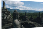 Statue of Buddha Sitting in a Stupa on Candi Borobudur by Anonymous