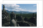Statue of Buddha Sitting in a Stupa on Candi Borobudur by Anonymous