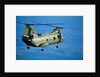 Military Helicopter Flying in Blue Skies by Anonymous