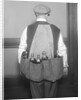 Man Wearing Coat Holding Bottles by Anonymous