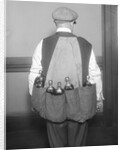 Man Wearing Coat Holding Bottles by Anonymous