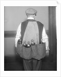 Man Wearing Coat Holding Bottles by Anonymous