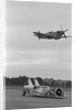 Airplane Flying Over Race Car in Action by Anonymous