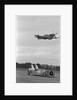 Airplane Flying Over Race Car in Action by Anonymous