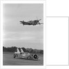 Airplane Flying Over Race Car in Action by Anonymous