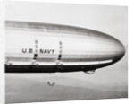 Plane Underneath Huge Dirigible in Flight by Anonymous