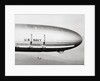 Plane Underneath Huge Dirigible in Flight by Anonymous