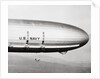 Plane Underneath Huge Dirigible in Flight by Anonymous