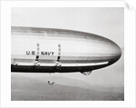 Plane Underneath Huge Dirigible in Flight by Anonymous