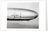 Plane Underneath Huge Dirigible in Flight by Anonymous