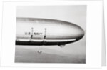 Plane Underneath Huge Dirigible in Flight by Anonymous