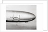 Plane Underneath Huge Dirigible in Flight by Anonymous