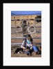 Cowboy and Dog Sitting Against Fence by Anonymous