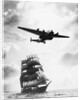 Airplane Flying over Ship by Corbis