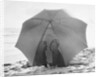 Couple on Beach Under Umbrella by Anonymous