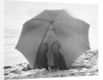 Couple on Beach Under Umbrella by Anonymous