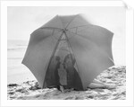 Couple on Beach Under Umbrella by Anonymous