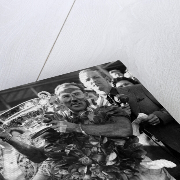 Sir Stirling Moss, racing driver after winning his first British Grand Prix in 1955 by Associated Newspapers