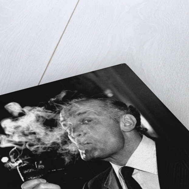 Boxer Henry Cooper smoking a pipe by Associated Newspapers