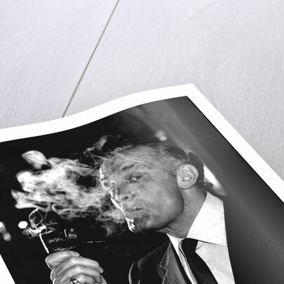 Boxer Henry Cooper smoking a pipe by Associated Newspapers