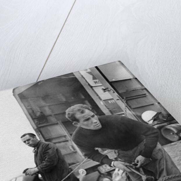 Stirling Moss maintains his car at the British Grand Prix by Associated Newspapers