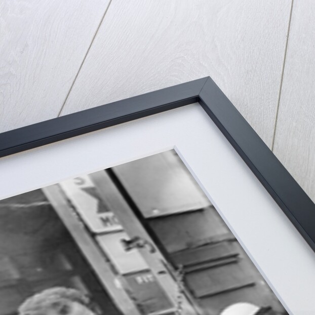 Stirling Moss maintains his car at the British Grand Prix by Associated Newspapers