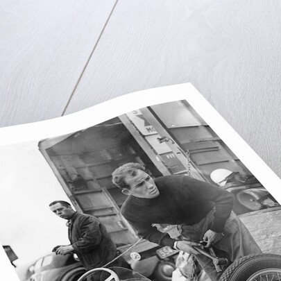 Stirling Moss maintains his car at the British Grand Prix by Associated Newspapers