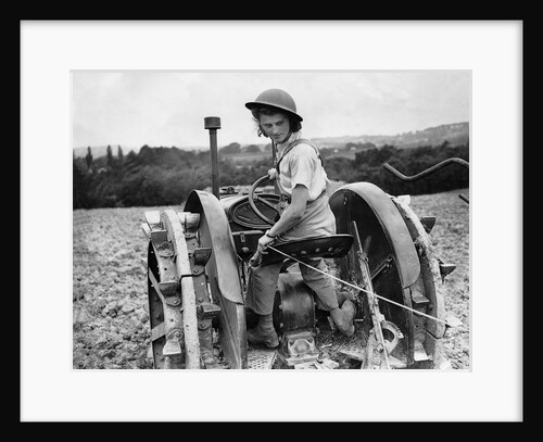 A Land Girl ploughing a field by Associated Newspapers