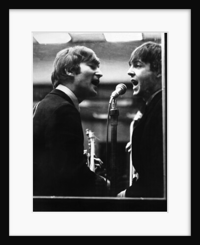 John Lennon and Paul McCartney in a recording studio by Associated Newspapers