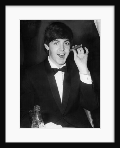 Paul McCartney with a cigar by Associated Newspapers