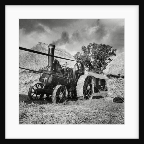 Traction engine driving  a threshing machine by Associated Newspapers