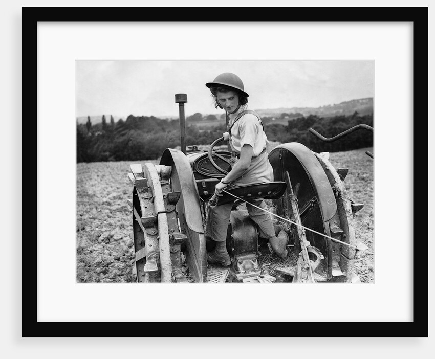 A Land Girl ploughing a field by Associated Newspapers