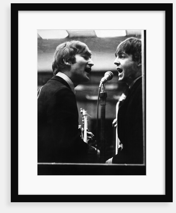 John Lennon and Paul McCartney in a recording studio by Associated Newspapers