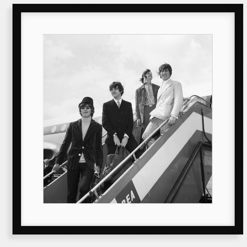 The Beatles on the steps of a plane by Associated Newspapers