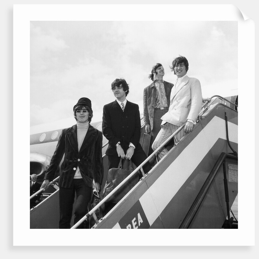The Beatles on the steps of a plane by Associated Newspapers