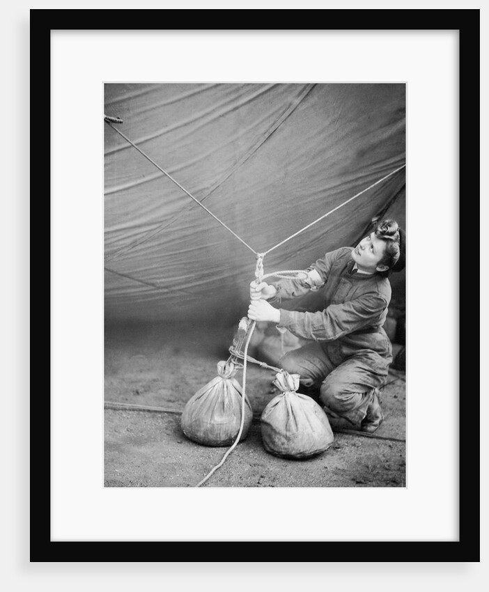WAAF checking barrage balloon by Associated Newspapers