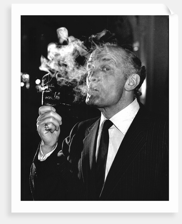 Boxer Henry Cooper smoking a pipe by Associated Newspapers
