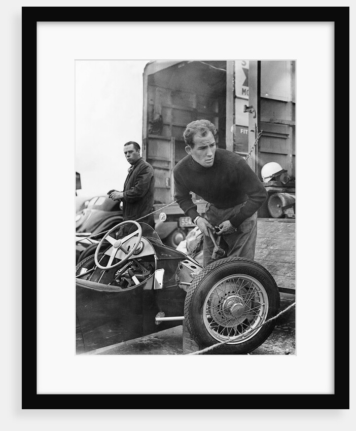 Stirling Moss maintains his car at the British Grand Prix by Associated Newspapers