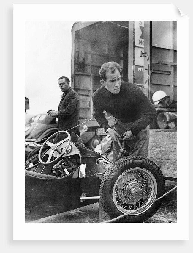 Stirling Moss maintains his car at the British Grand Prix by Associated Newspapers