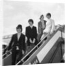 The Beatles on the steps of a plane by Associated Newspapers