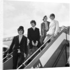 The Beatles on the steps of a plane by Associated Newspapers